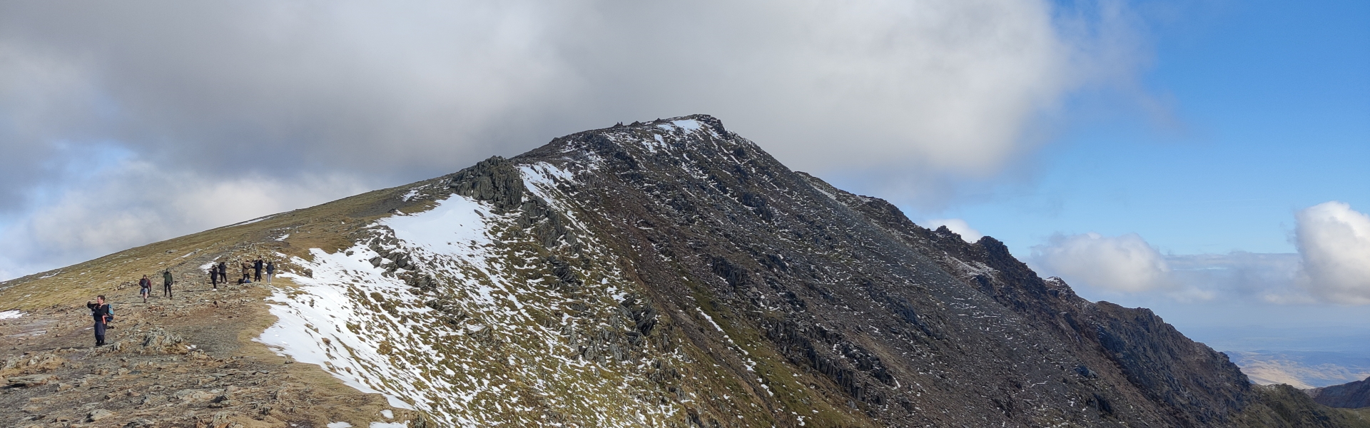 The curving, snowy summit of Snowdon, Wales